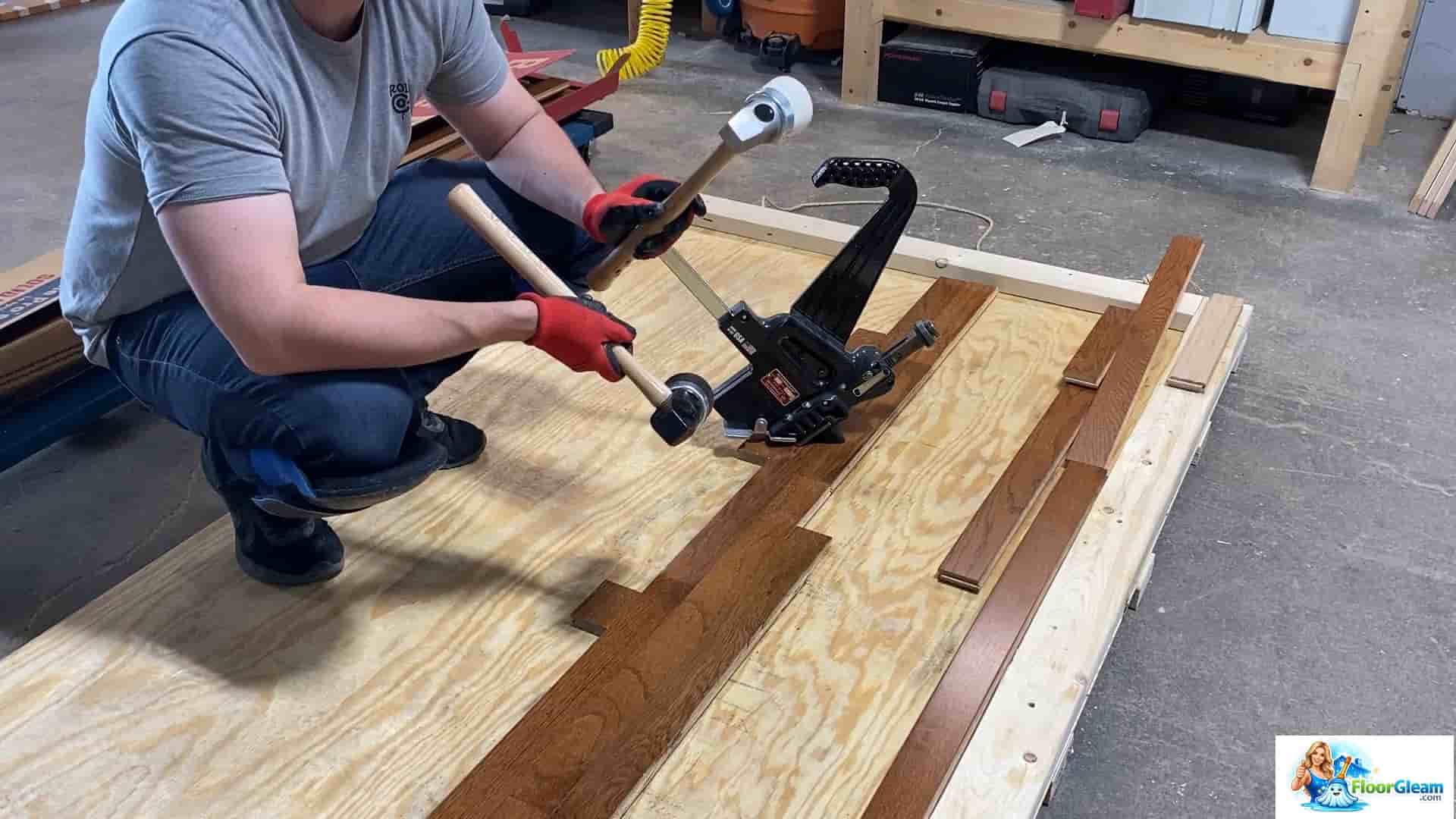 A professional worker using the best nail gun for wood floors on oak planks